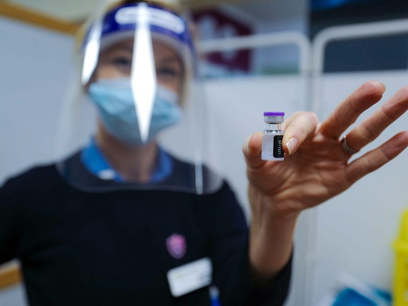 Nurse administering a COVID-19 vaccine at Royal Cornwall Hospital