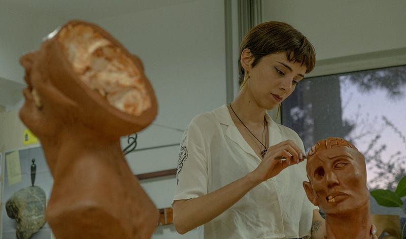 A researcher examining a brain model in a lab setting.