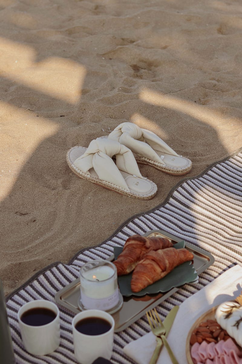 A serene beach scene with a book and blanket