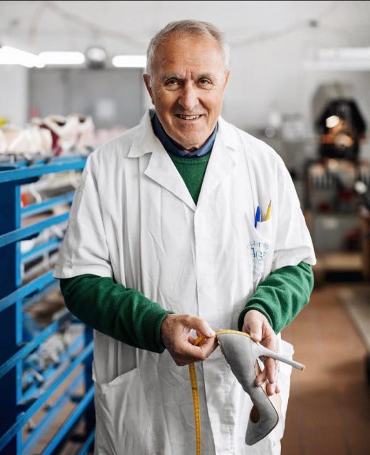 Factory worker examining AI-generated shoe designs