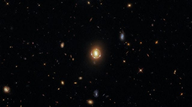 Hubble's capture of an Einstein Ring demonstrating gravitational lensing.