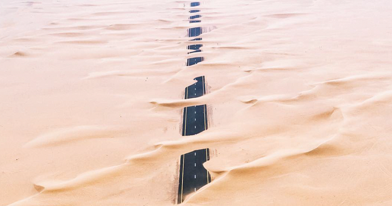 A highway in the desert highlighting human-nature conflict.